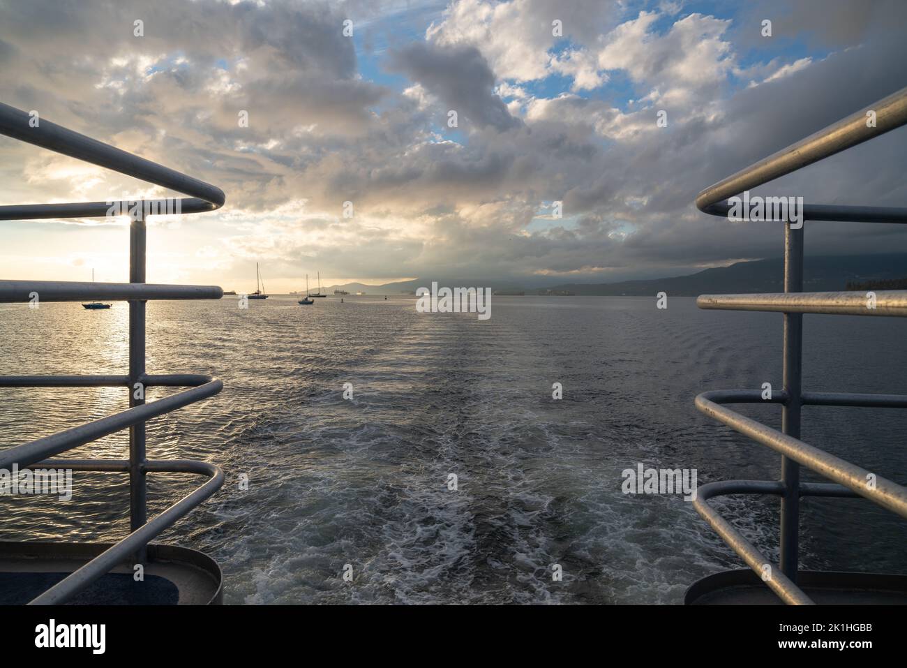 View from the taffrail of a whale watching ship, looking out over Burrard Inlet and all of the boats and container ships waiting offshore. Stock Photo