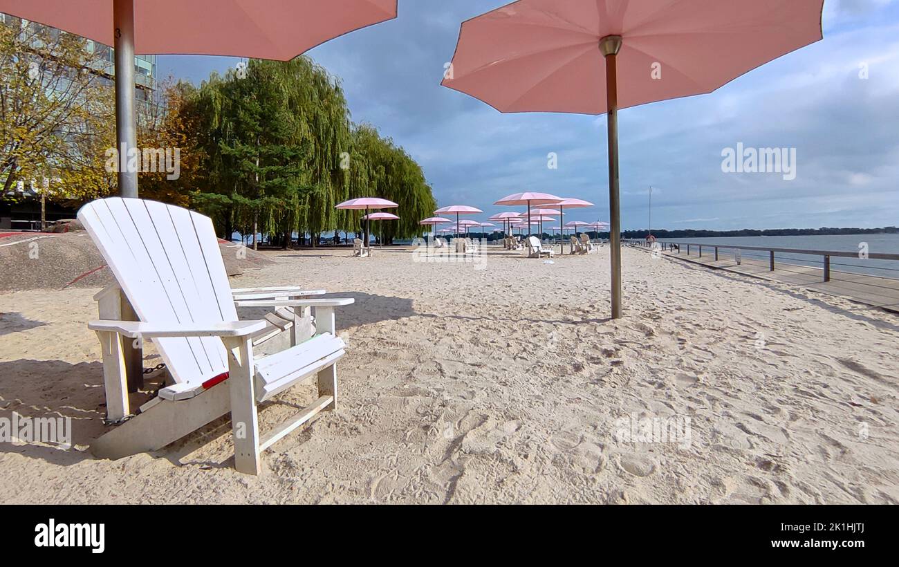 Adirondack chairs with pink umbrellas at Sugar Beach, Toronto Stock