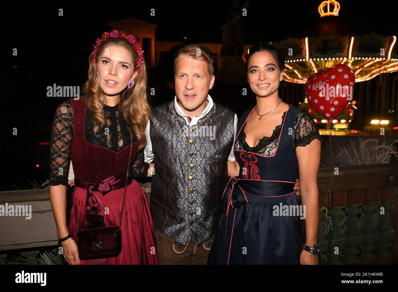 Munich, Germany. 18th Sep, 2022. Singer Victoria Swarovski, (l-r), comedian  Oliver Pocher and his wife Amira celebrate at the "Almauftrieb" in front of  the Käfer tent at the Oktoberfest. The "Almauftrieb" is