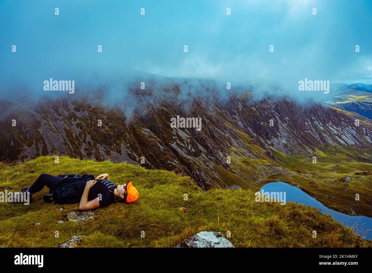 A hiker rests in Snowdonias Stock Photo