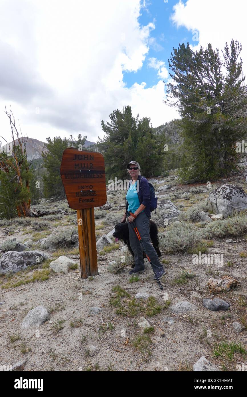 Woman hiking with dog in the John Muir wilderness of the Inyo National forest California ; USA Stock Photo