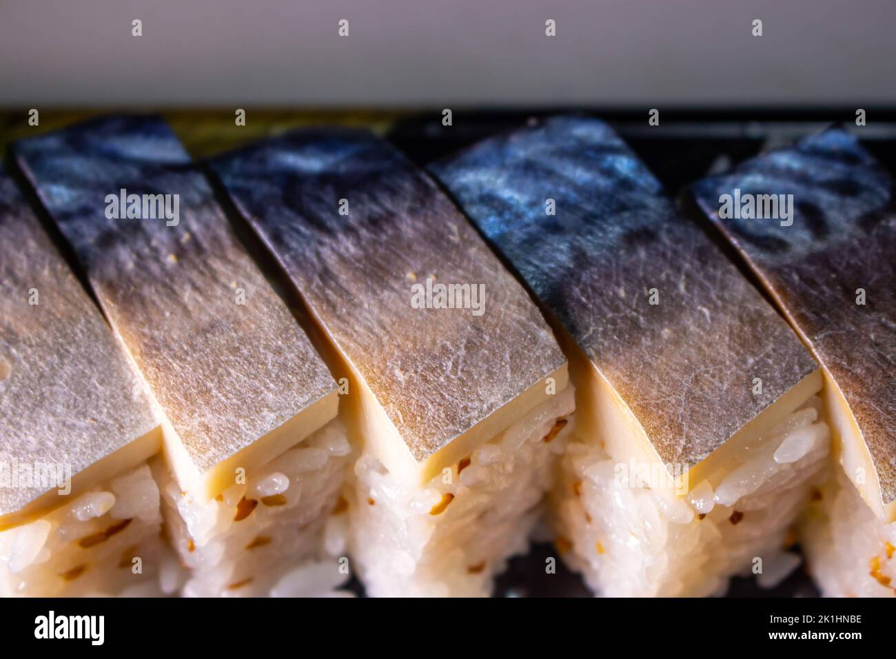 Saba Sushi (Saba Oshizushi, Mackerel Pressed Sushi). Oshi Zushi is a form of sushi which made by compressing sushi rice with fish and toppings Stock Photo