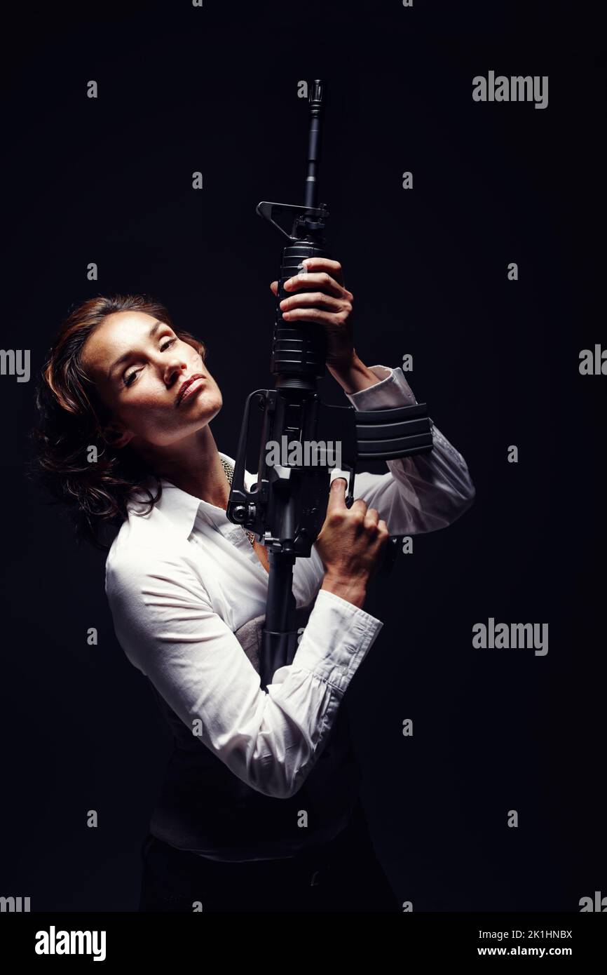 Controlled and confident. a mature woman holding a rifle and looking serious. Stock Photo