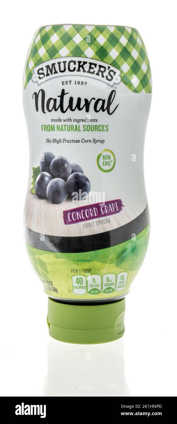 Winneconne, WI - 11 September 2022: A bottle Smuckers natural concord grape fruit spread on an isolated background. Stock Photo