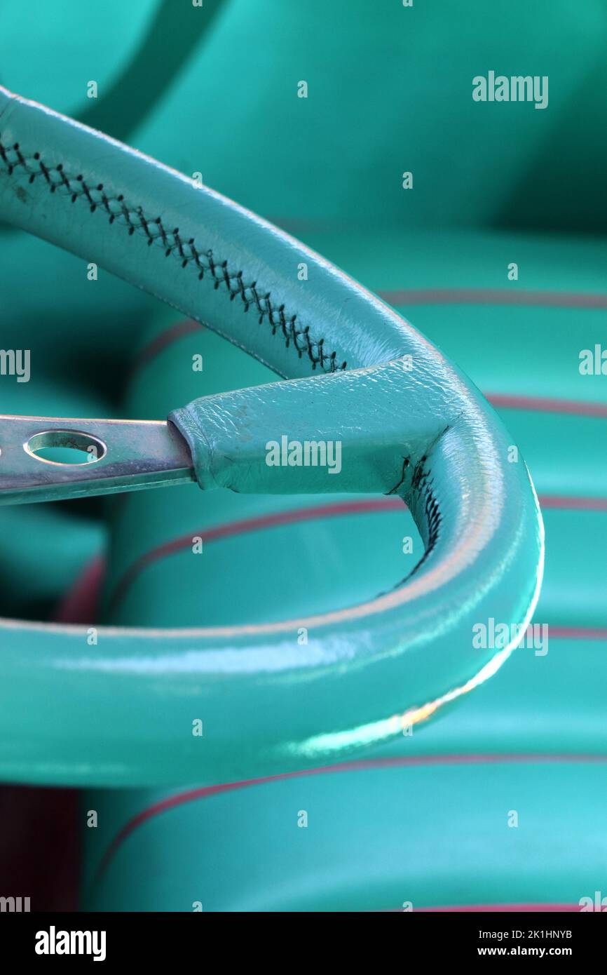 Teal blue leather steering wheel and bucket seat of a classic vintage car. Stock Photo