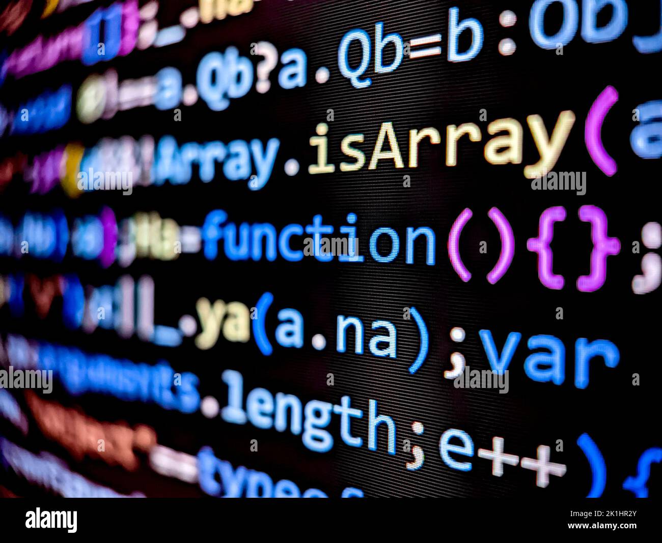 Closeup of software code on a computer screen with colorful letters and ...