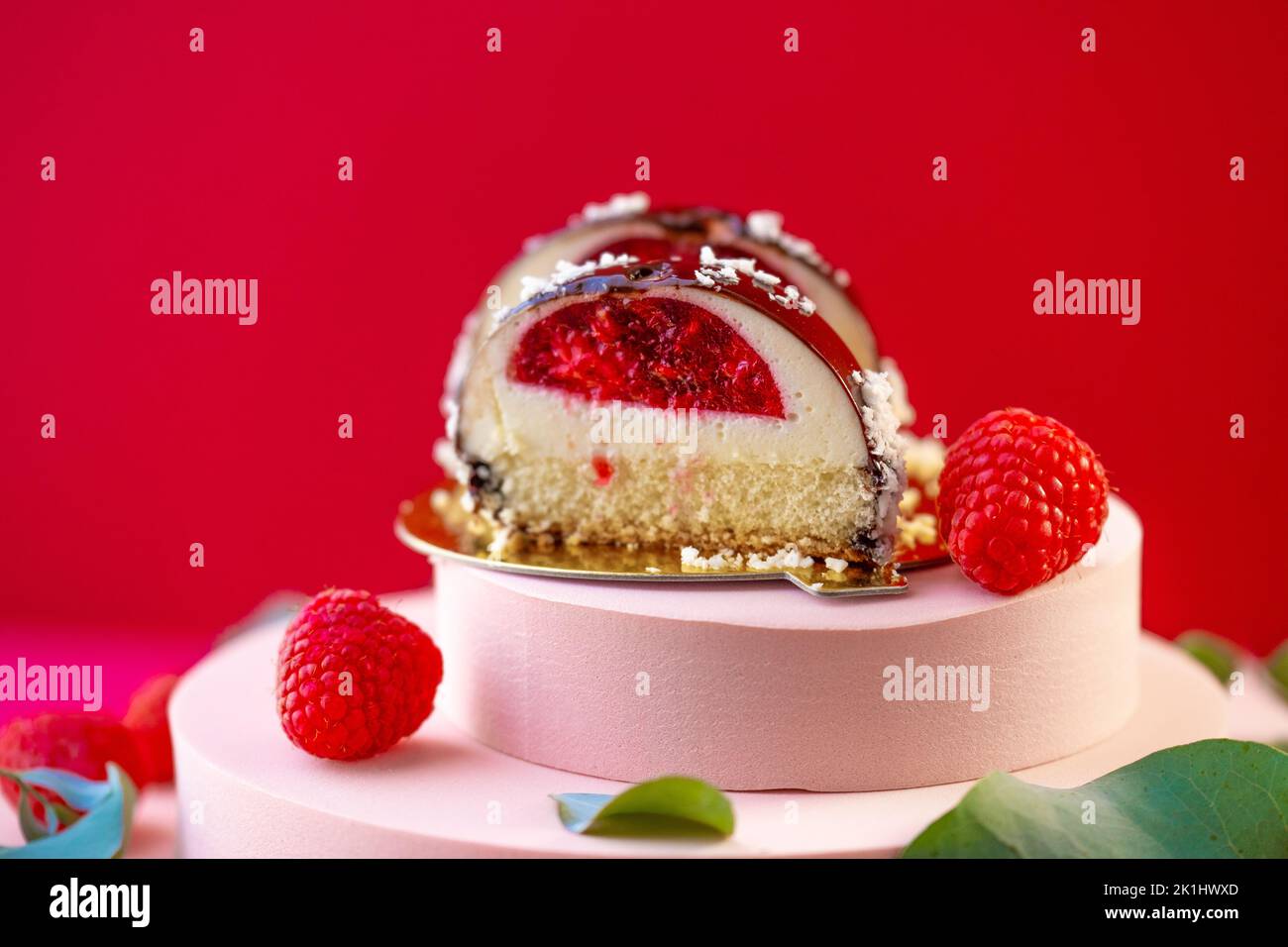 Berry dessert. round cake with raspberry filling cut and raspberries on ...