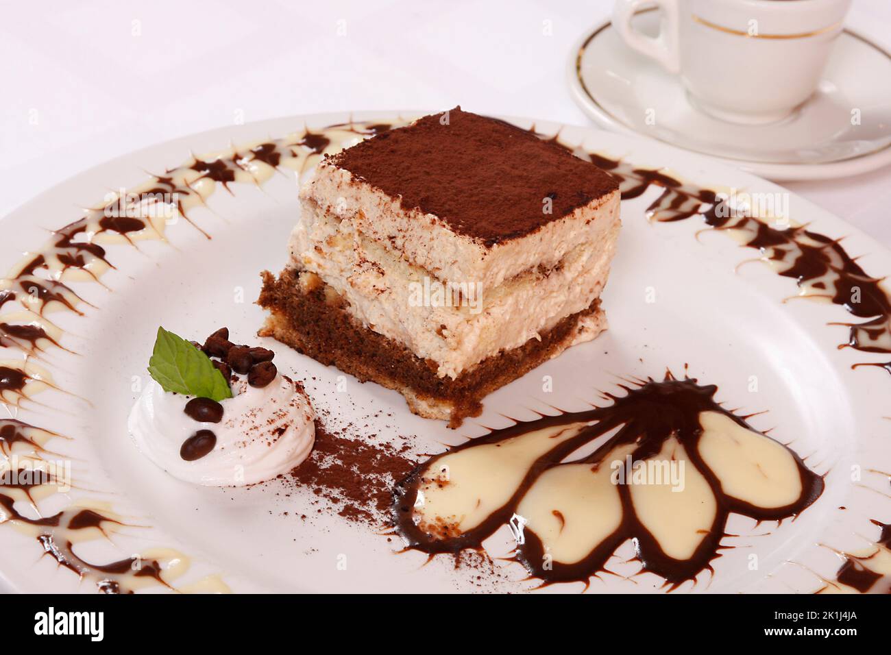 Chocolate cake with custard on the dessert plate Stock Photo Alamy