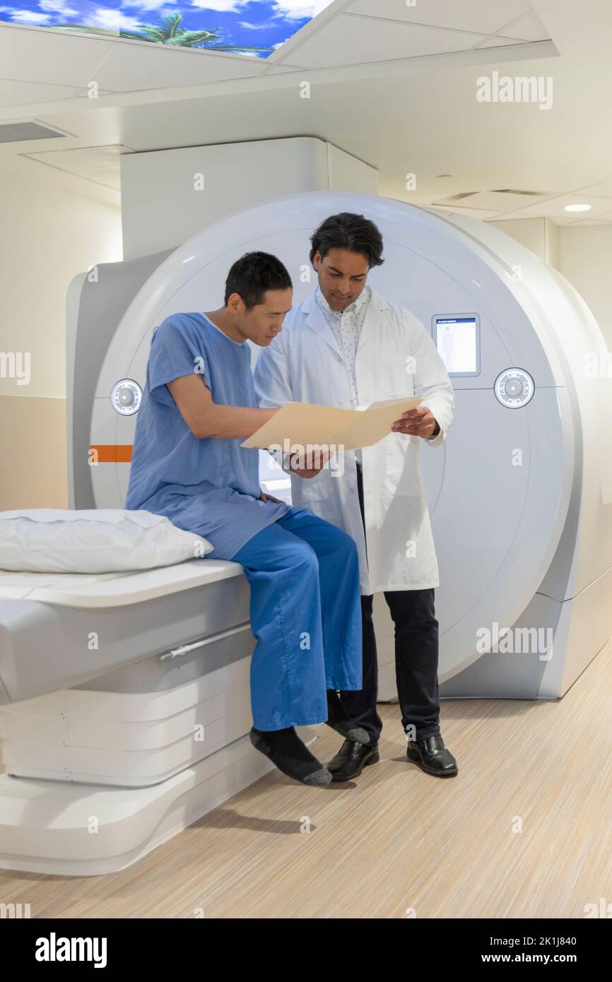 Radiology technologist showing MRI scans to patient Stock Photo