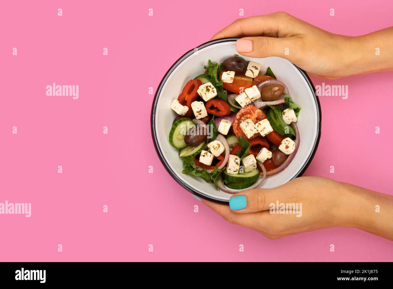 Greek salad on color background. Traditional food. Creative photo concept. Top view, copy space Stock Photo