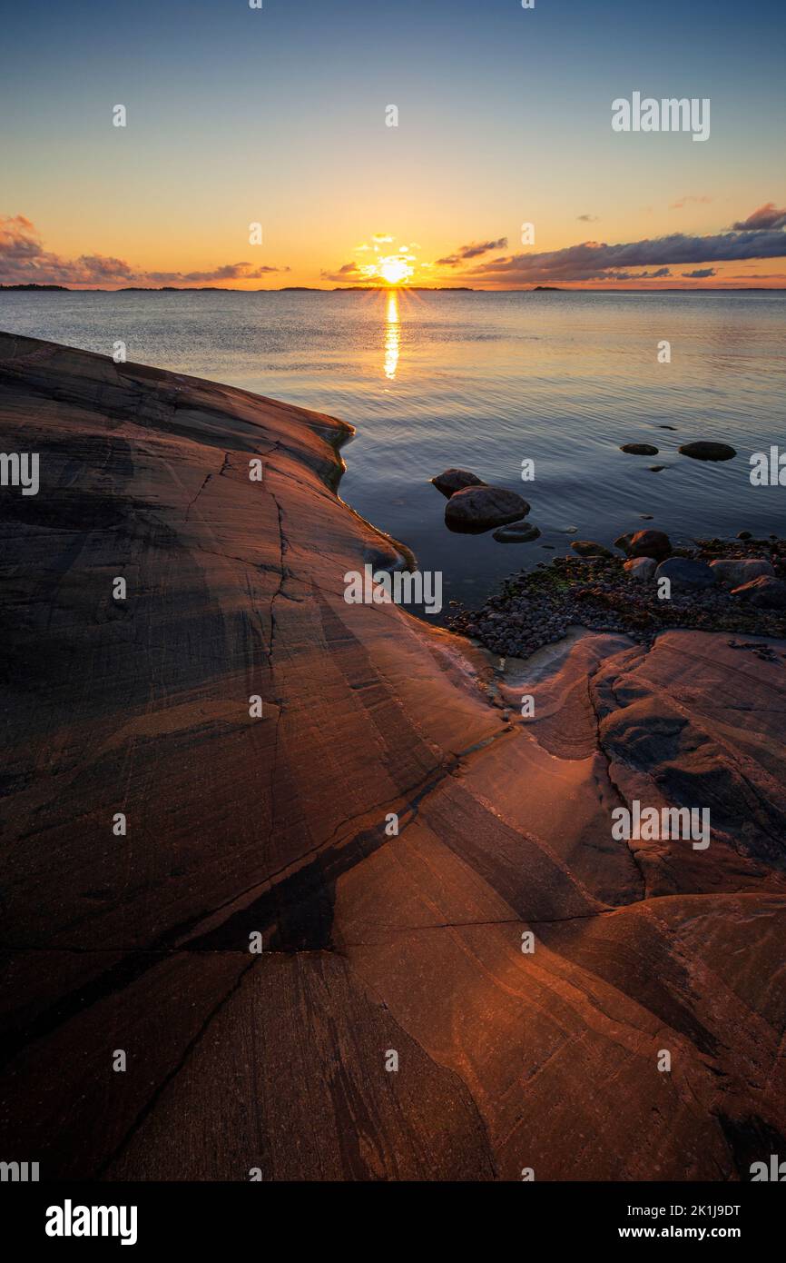 Beautiful view of rocky coastline and cliff and the Baltic Sea in Hanko, Finland, at sunset in the summer. Stock Photo