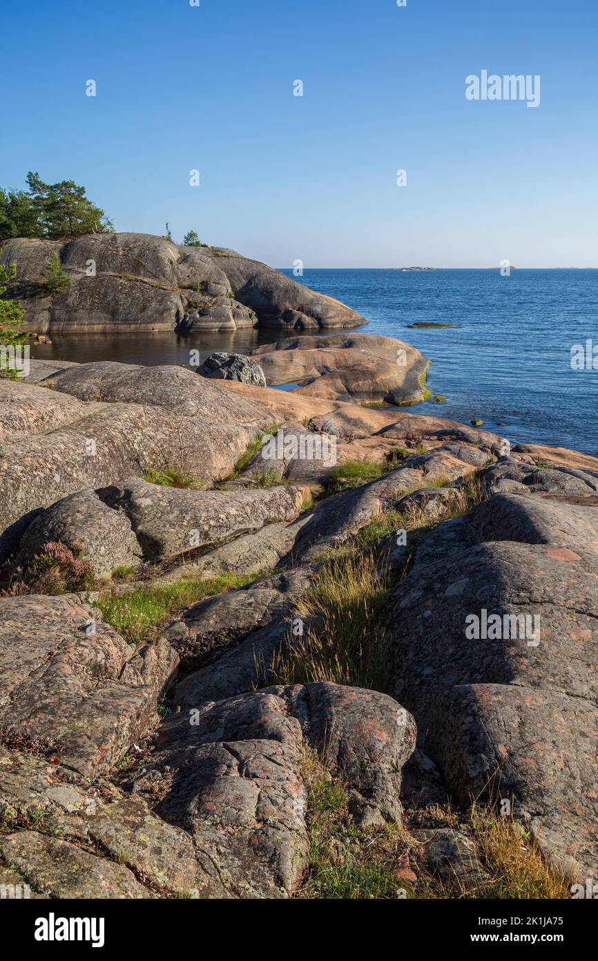 Rocky coastline and shoreline cliffs at Puistovuori in Hanko, Finland, on a sunny day in the summer. Stock Photo