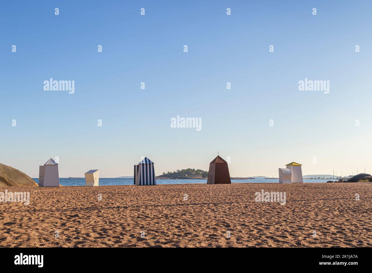 Wooden changing booths or huts at the empty and sandy Casino beach in downtown Hanko, Finland, on a sunny day in the summer. Copy space. Stock Photo