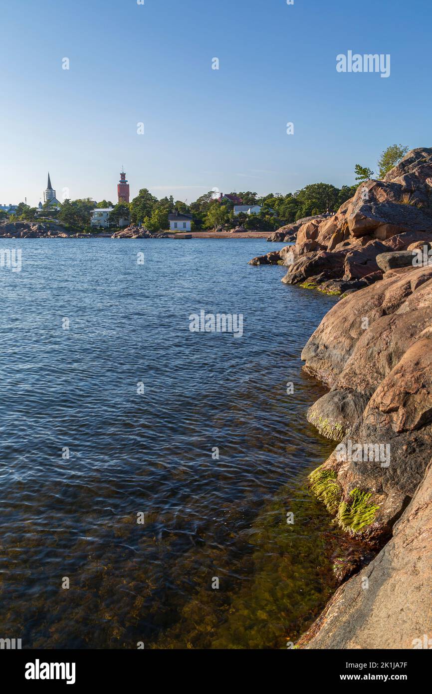 Rocky coastline and shoreline cliffs at Puistovuori and cityscape in Hanko, Finland, on a sunny day in the summer. Stock Photo