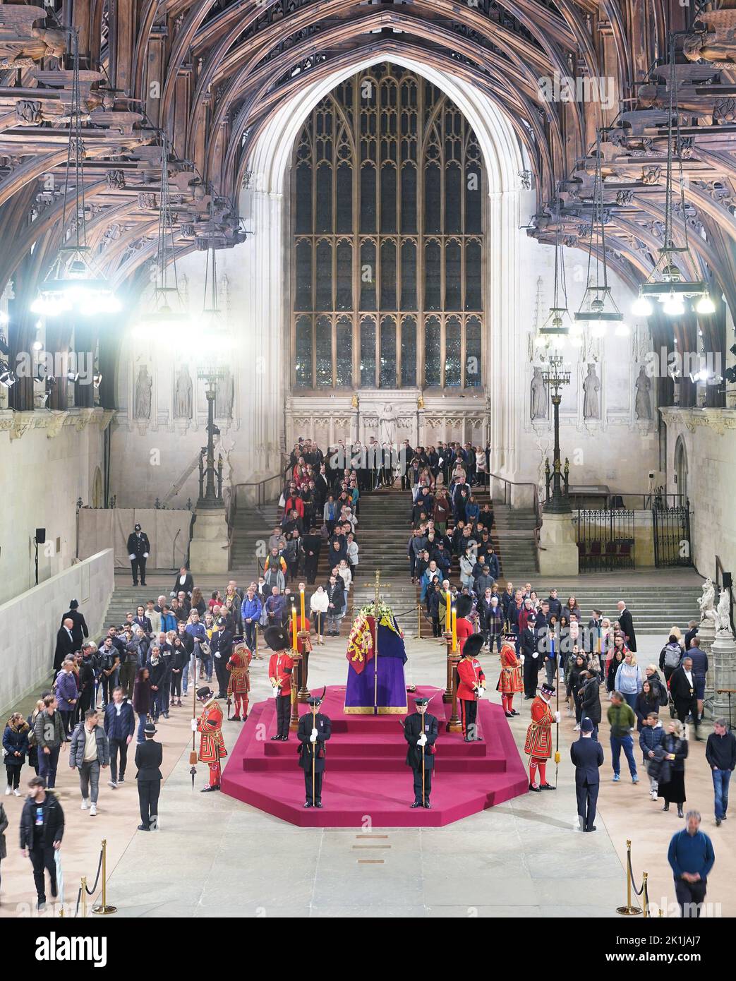 At 5.05am on the day of her funeral the final members of the public pay their respects at the coffin of Queen Elizabeth II, draped in the Royal Standard with the Imperial State Crown and the Sovereign's orb and sceptre, lying in state on the catafalque in Westminster Hall, at the Palace of Westminster, London. Picture date: Monday September 19, 2022. Stock Photo