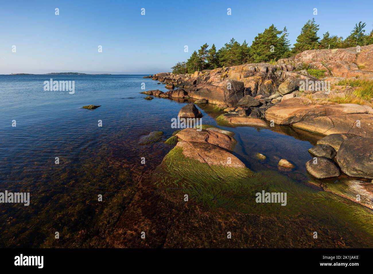 Rocky coastline and shoreline cliffs along the Tulliniemi nature trail leading to the southernmost point of Finnish mainland in Hanko, Finland. Stock Photo