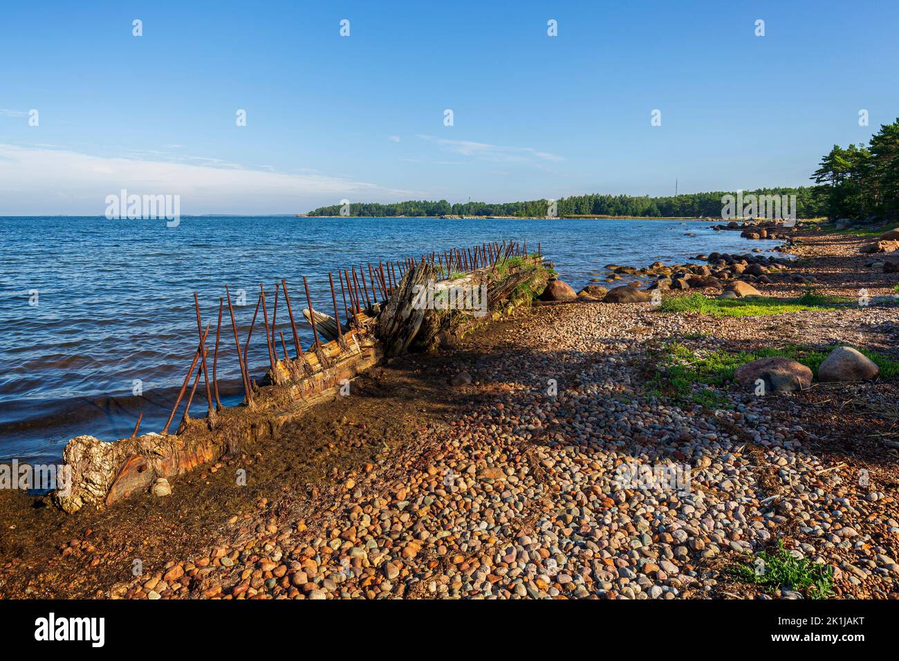 Old shipwreck at the rocky coastline along the Tulliniemi nature trail in Hanko, Finland, on a sunny day in the summer. Stock Photo