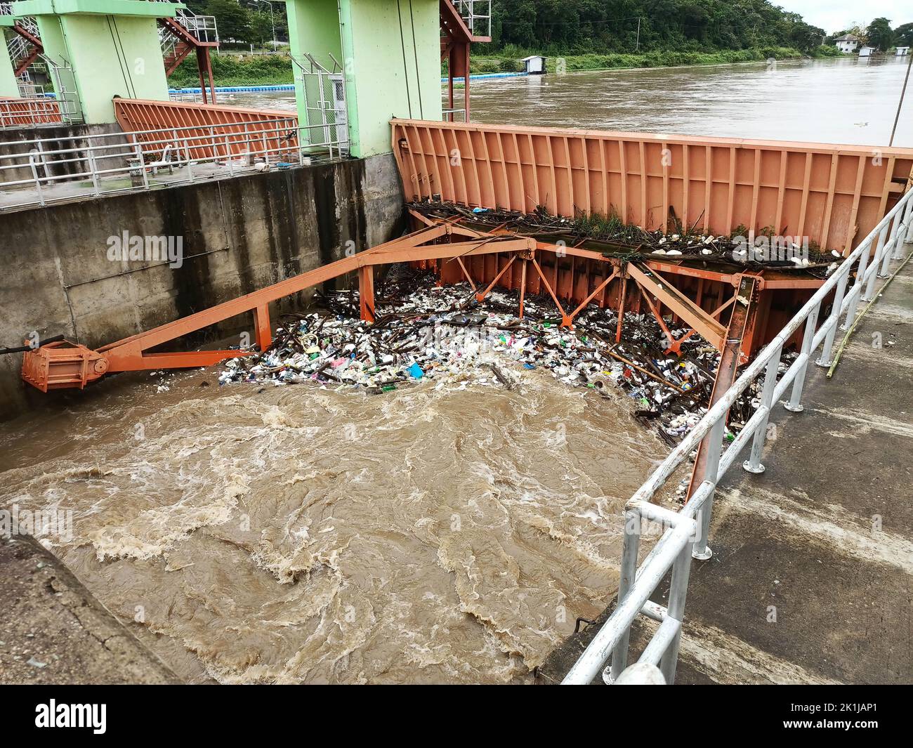 Aerial view of turbid brown forest water released by concrete dam