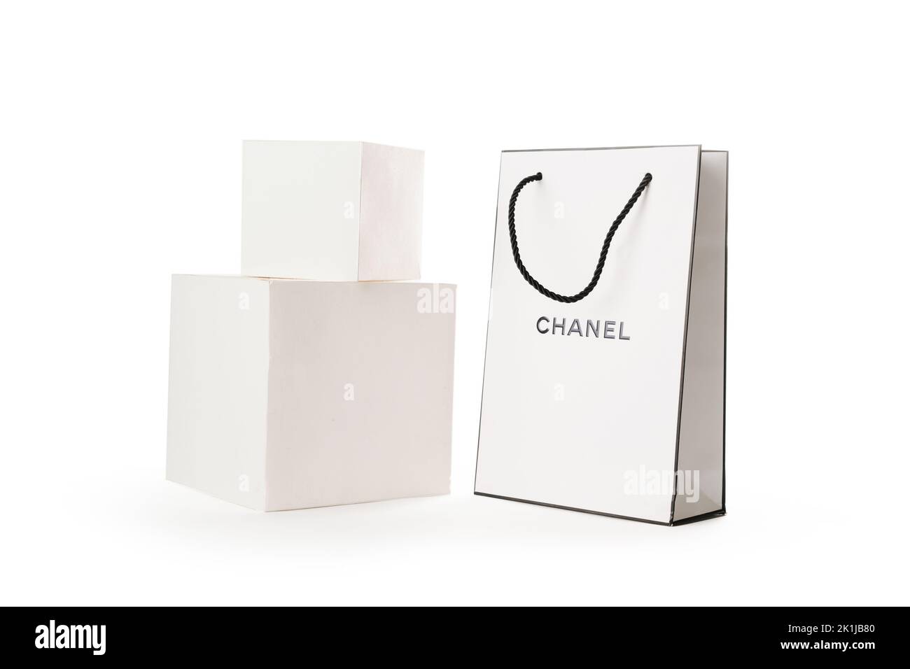 Cyprus, Paphos - SEPTEMBER 08, 2022: Composition of branded paper bag of Chanel perfume shop next to white cubes. Over white background. Stock Photo