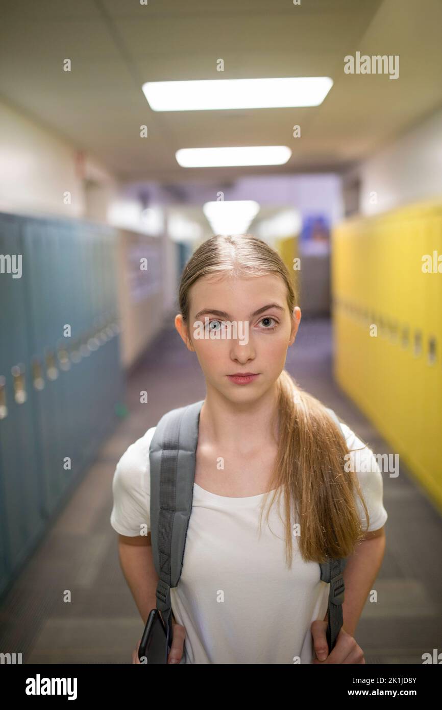 Portrait confident junior high girl student in corridor Stock Photo Alamy