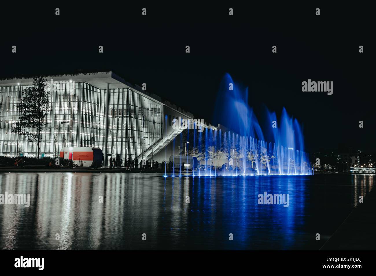 A night shot of The Stavros Niarchos Center in Athens with fountains in a blue light Stock Photo