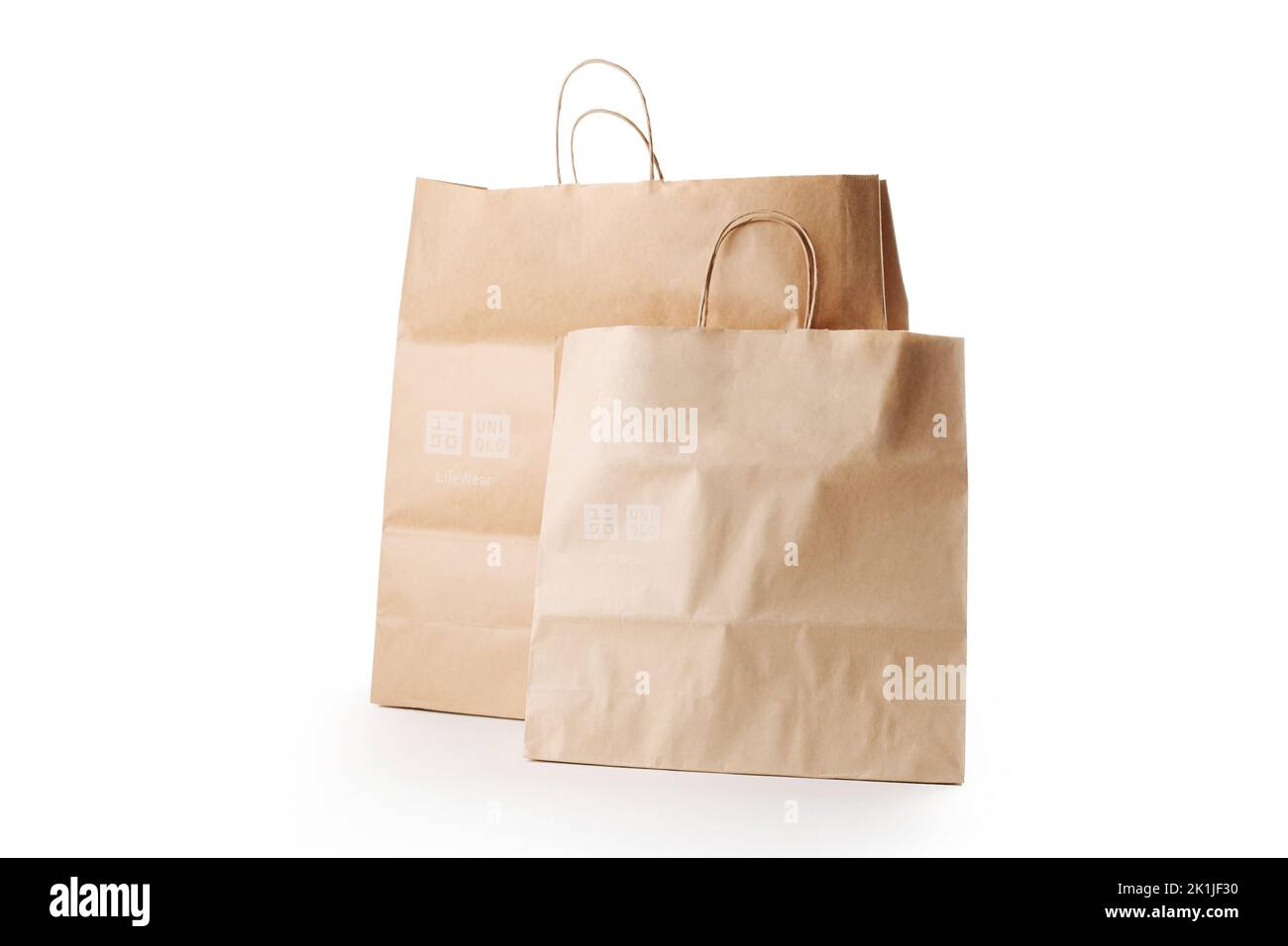 Cyprus, Paphos - SEPTEMBER 08, 2022: Pair of Uniqlo paper bag from Japanese casual clothes brand. Over white background. Stock Photo