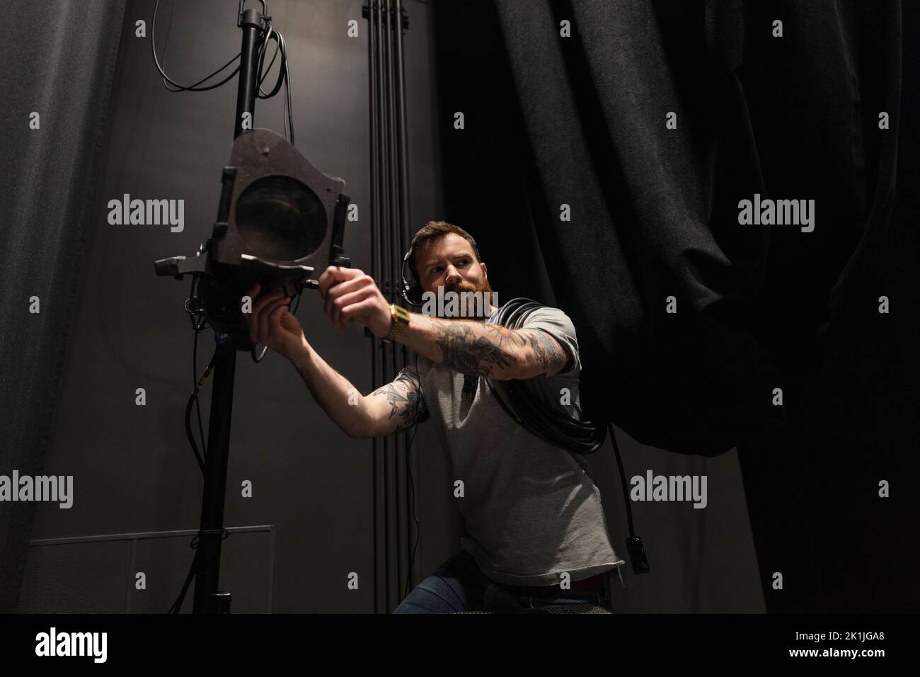Male stage manager adjusting stage lights Stock Photo Alamy