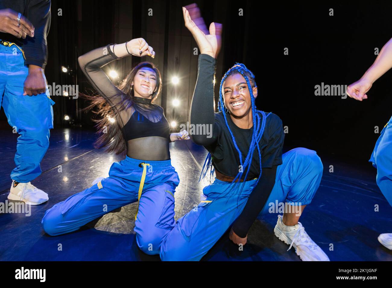 Portrait confident young female hiphop dancers performing on stage