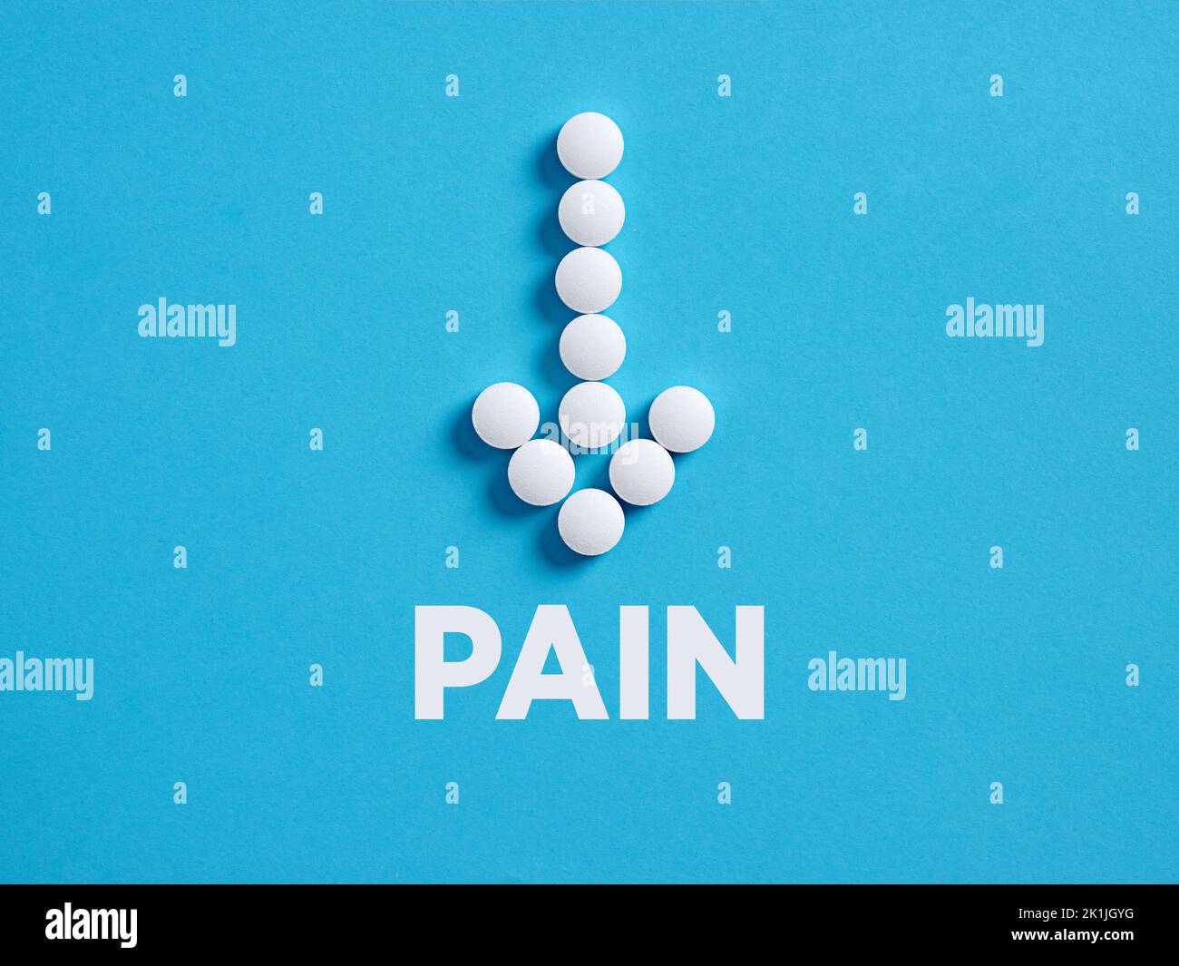 Medical pills in arrow shape with the word pain. Painkiller or reducing pain concept. Stock Photo