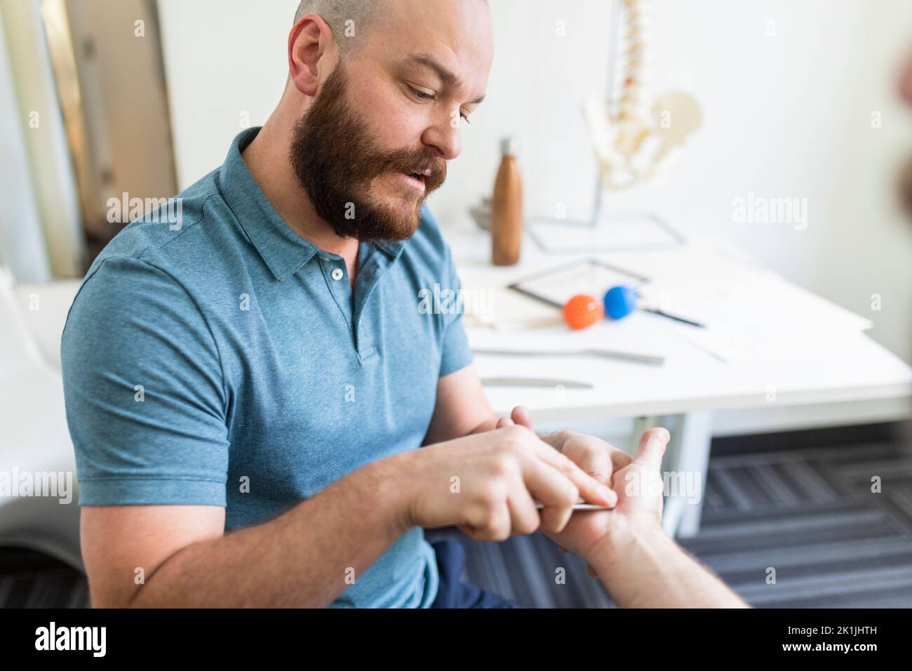 Naturopathic doctor using alternative medicine diagnostic tool on