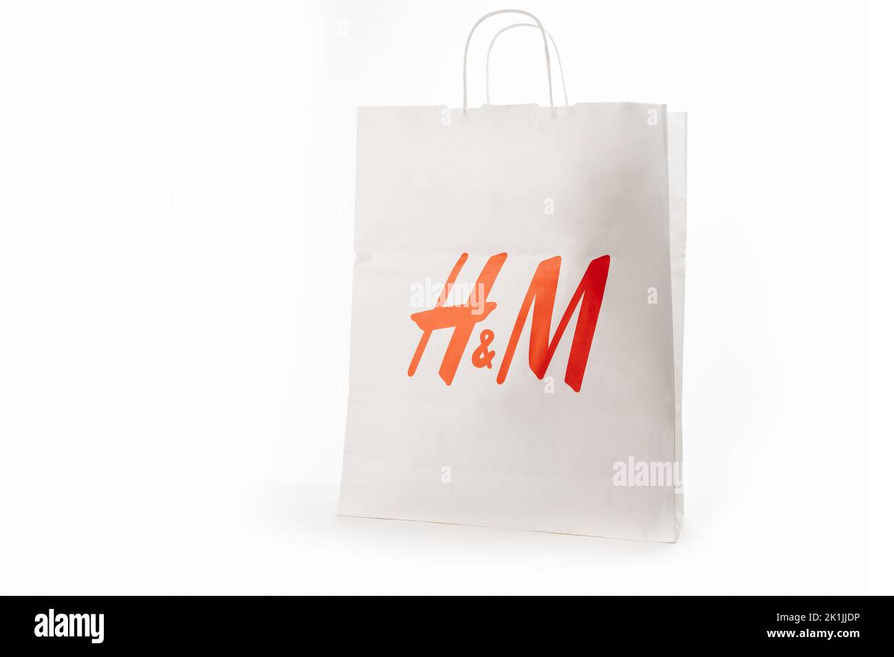 Cyprus, Paphos - SEPTEMBER 08, 2022: HM paper bag from famous swedish fast-fashion clothing brand. Over white background. Stock Photo