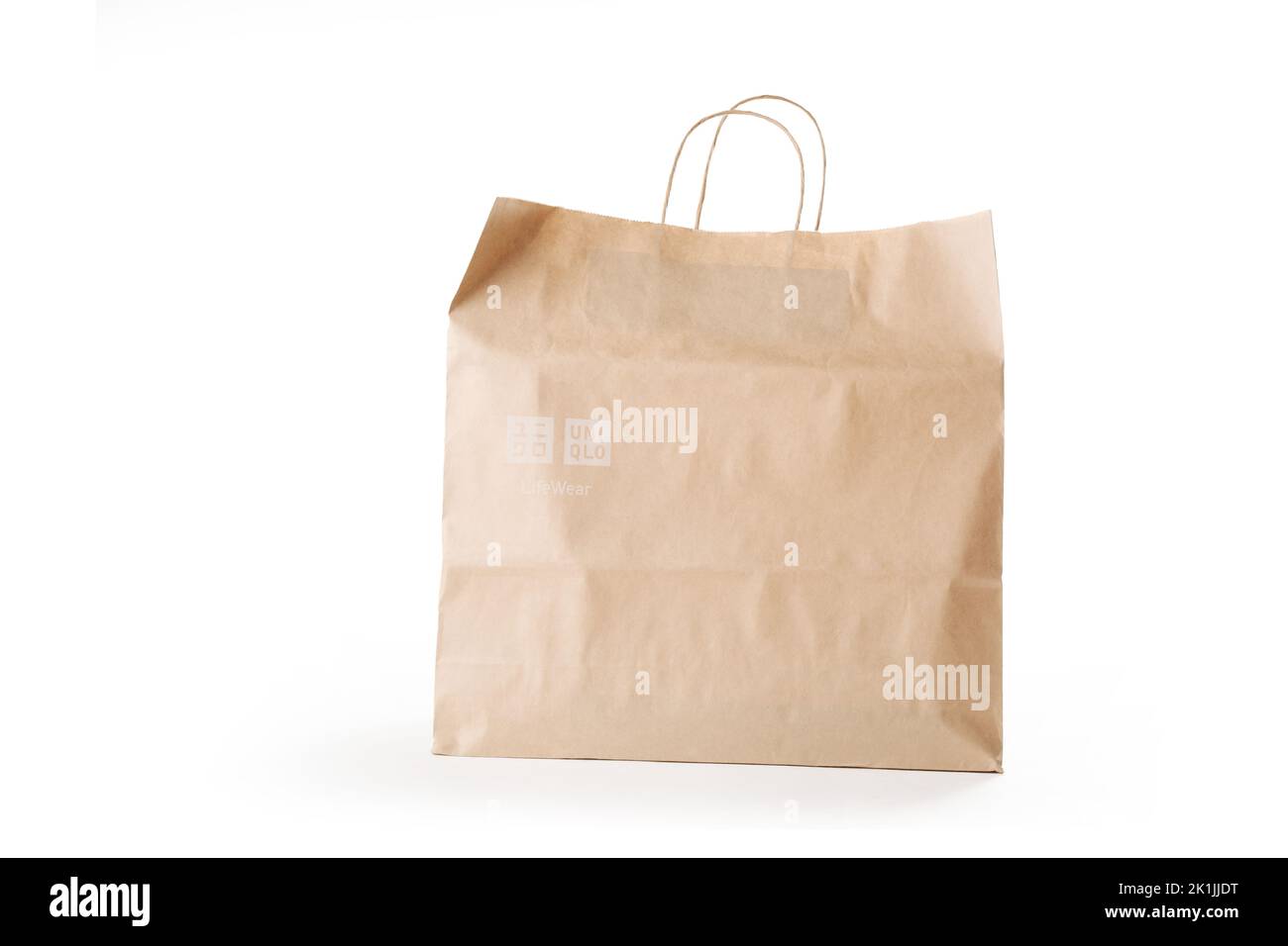 Cyprus, Paphos - SEPTEMBER 08, 2022: Uniqlo paper bag from Japanese casual clothes brand. Over white background. Stock Photo