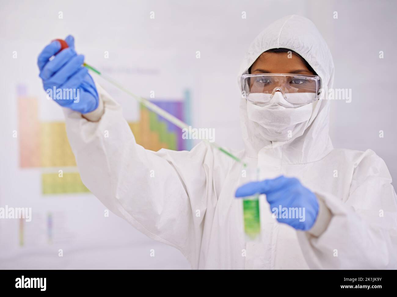 Working cleverly and carefully. A young scientist in protective