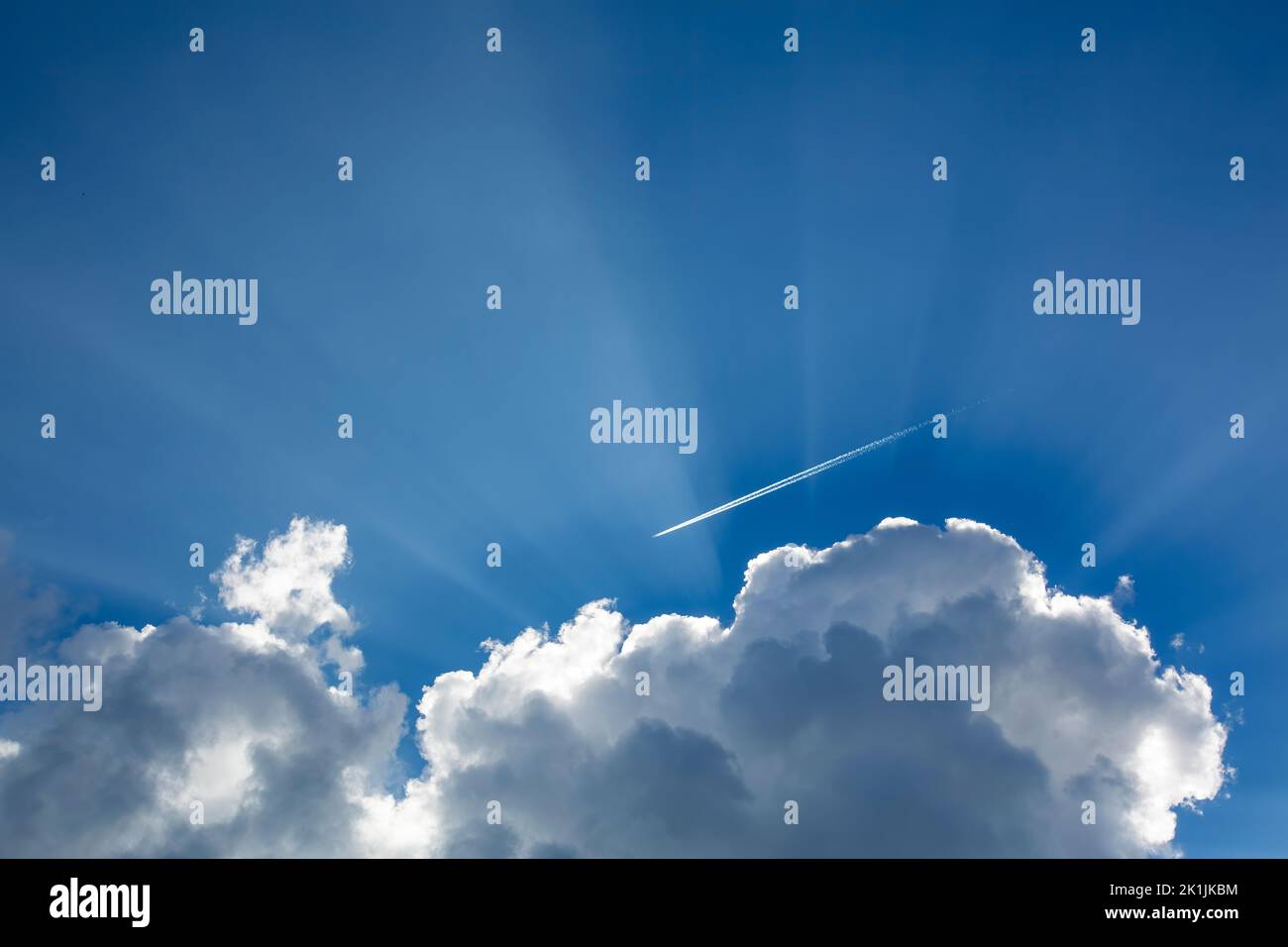 Beautiful skyscape with sun rays behind the clouds Stock Photo
