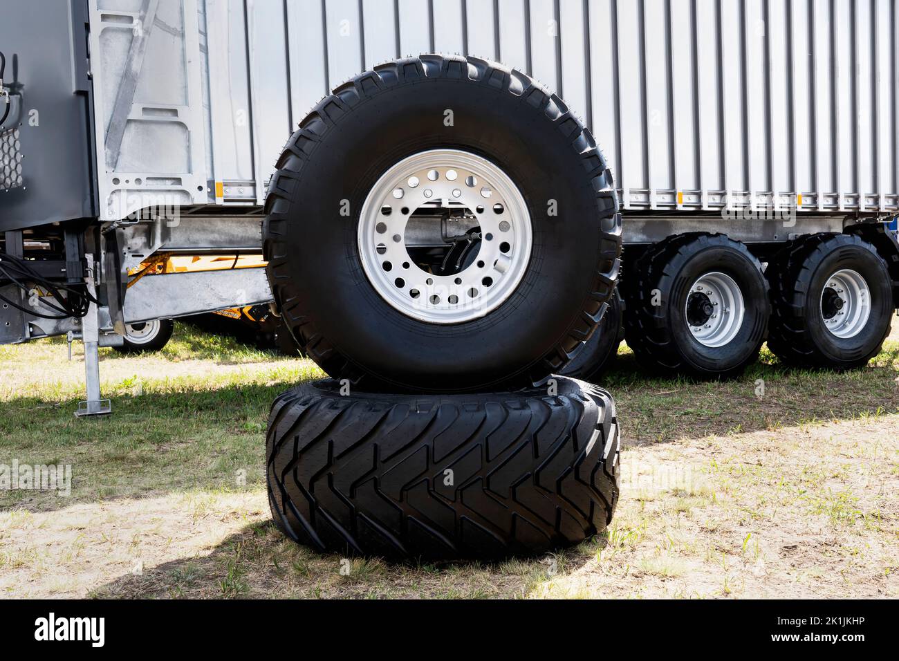 Truck wheels waiting to change. new truck tires on the background of a large trailer. Stock Photo