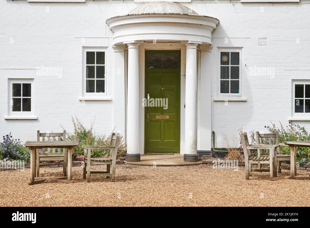 Picnic tables and chairs outside a house in the botanic garden at the University of Cambridge, England. Stock Photo