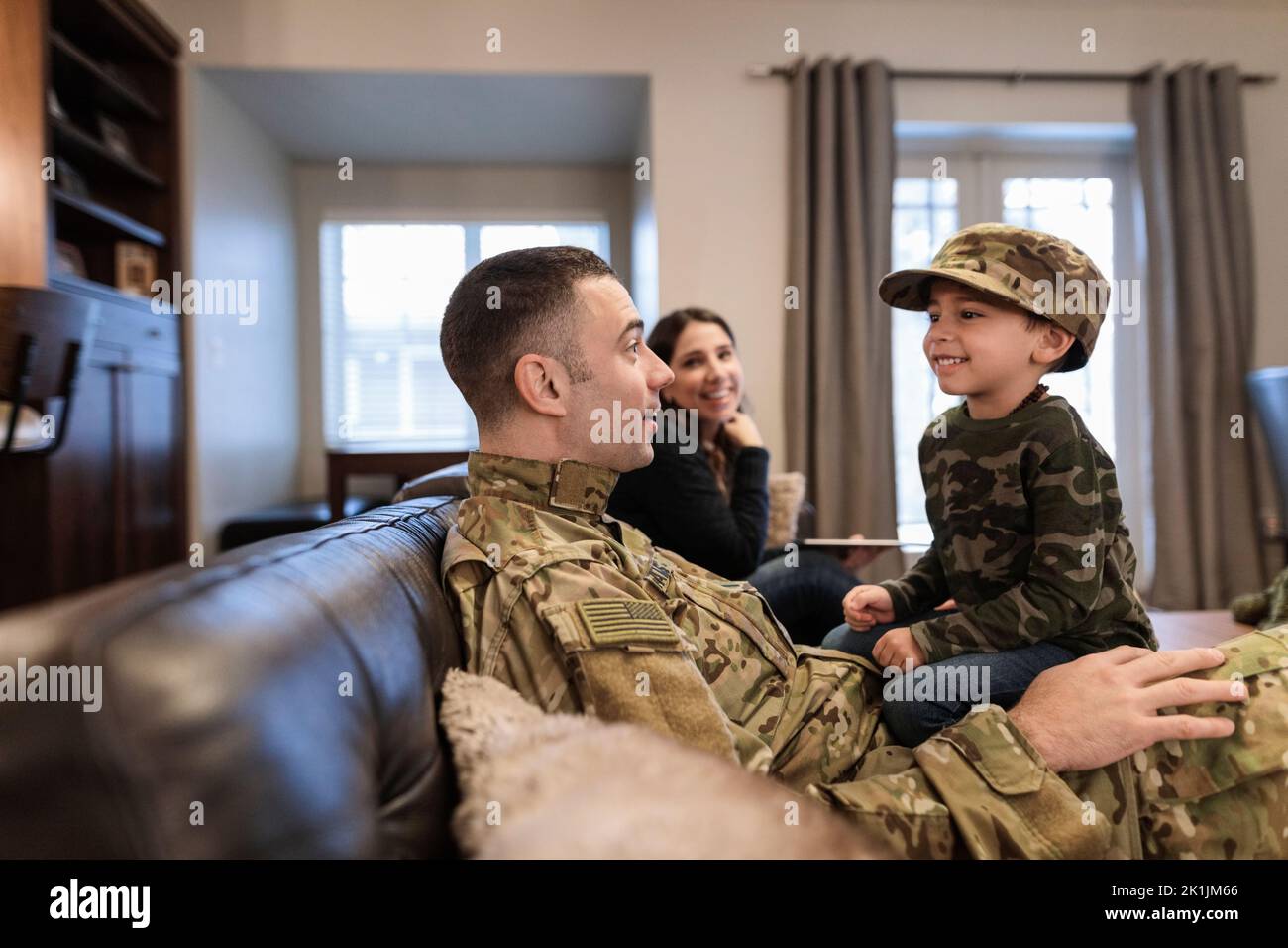 Military family on living room sofa Stock Photo Alamy