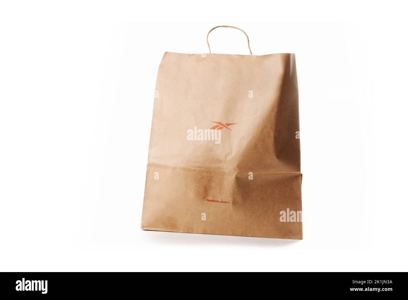 Cyprus, Paphos - SEPTEMBER 08, 2022: Reebok paper bag from famous sportswear brand. Over white background. Stock Photo