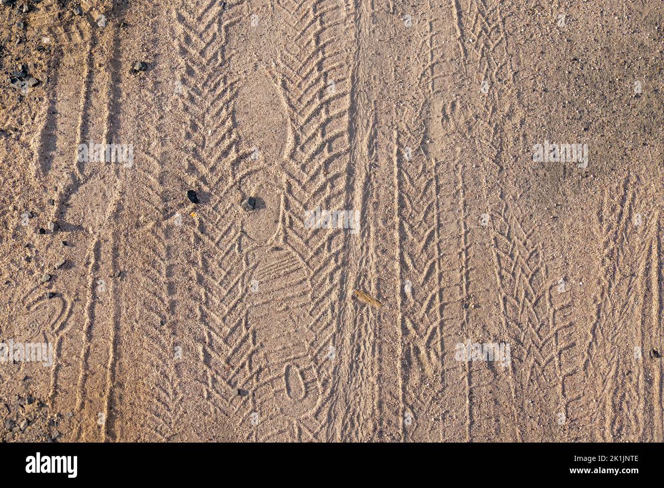Bicycle tire tracks and footprints in sand, copy space Stock Photo Alamy