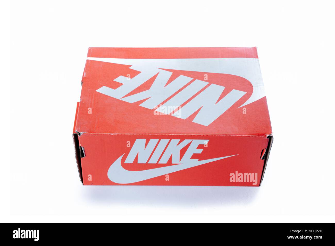 Cyprus, Paphos - SEPTEMBER 08, 2022: Nike red box of footwear from famous sportswear brand. diagonaly placed. Over white background. Stock Photo