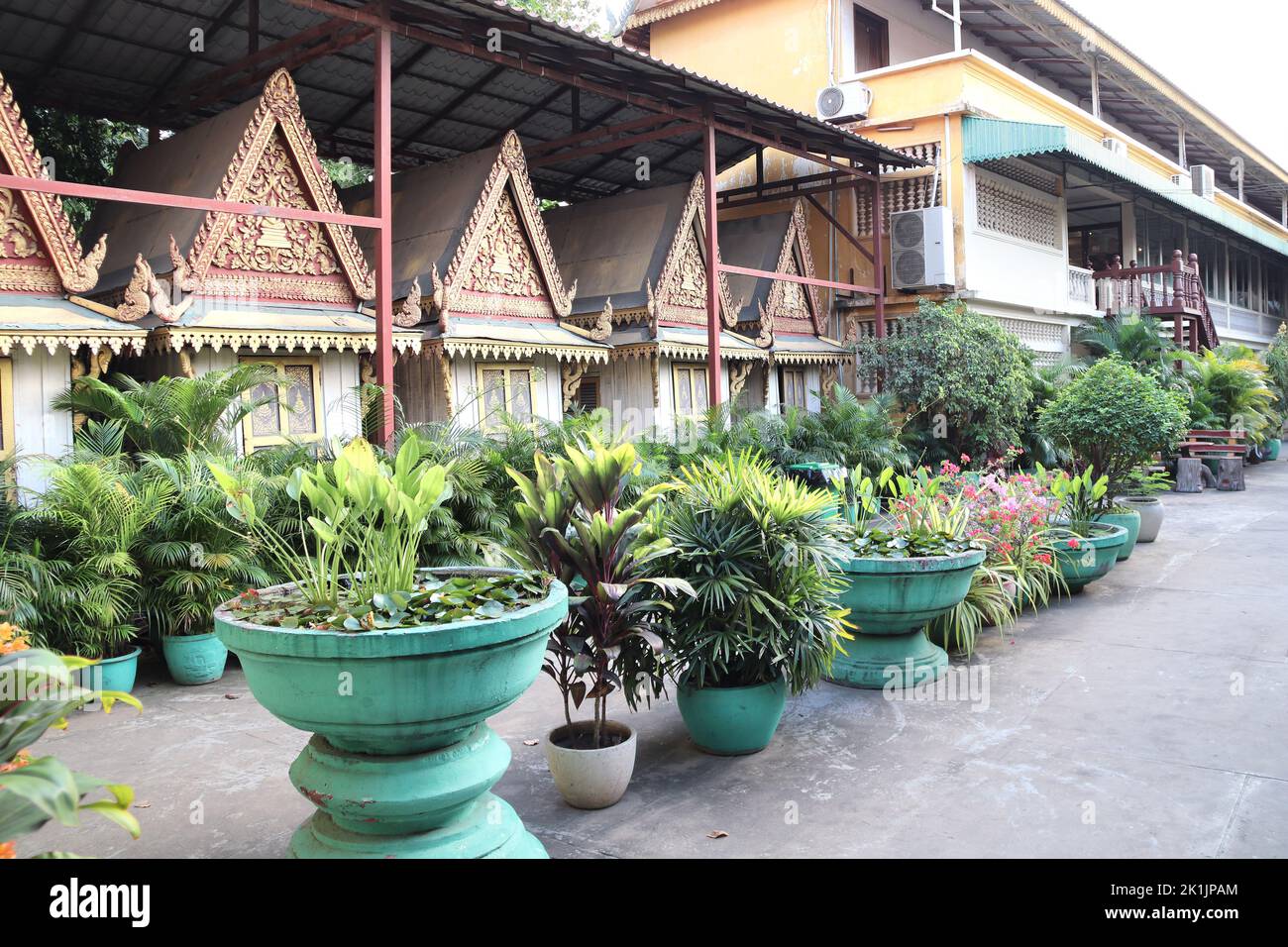 Decorative pavilion and tropical plants in clay pots, garden of Royal Palace complex, Phnom Penh, Cambodia Stock Photo