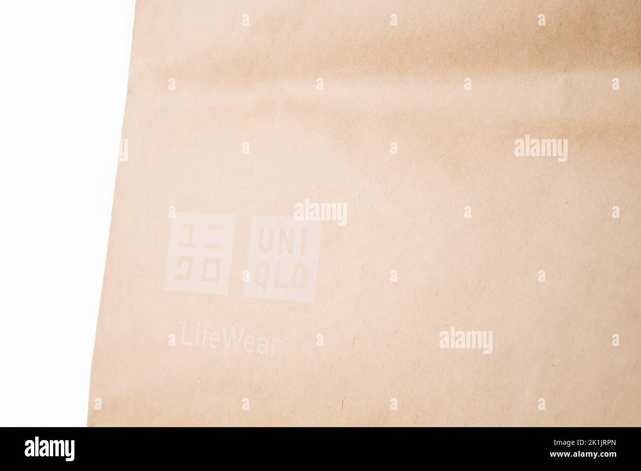 Cyprus, Paphos - SEPTEMBER 08, 2022: Close caption of Uniqlo paper bag from Japanese casual clothes brand. Over white background. Stock Photo