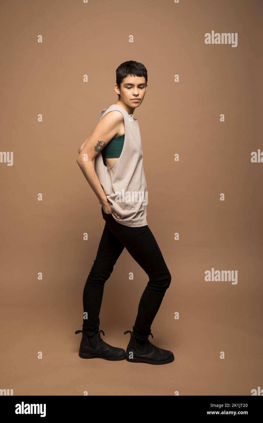 Portrait of cool young nonbinary man in tank top Stock Photo