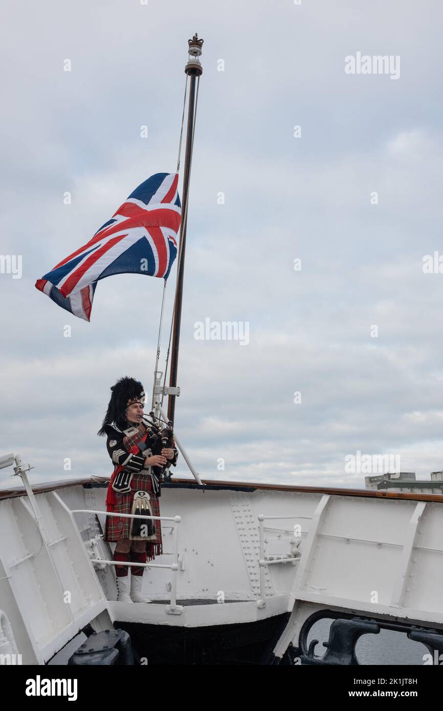 Edinburgh, UK. 19 September 2022. Pipe Major Steven Dewar, of Scotia Pipers, plays a salute to Her Majesty Queen Elizabeth II who died on 8th September, on board the Royal Yacht Britannia moored in Leith docks, in Edinburgh, UK. 19 September 2022. Photo credit: Jeremy Sutton-Hibbert/Alamy Live News. Stock Photo