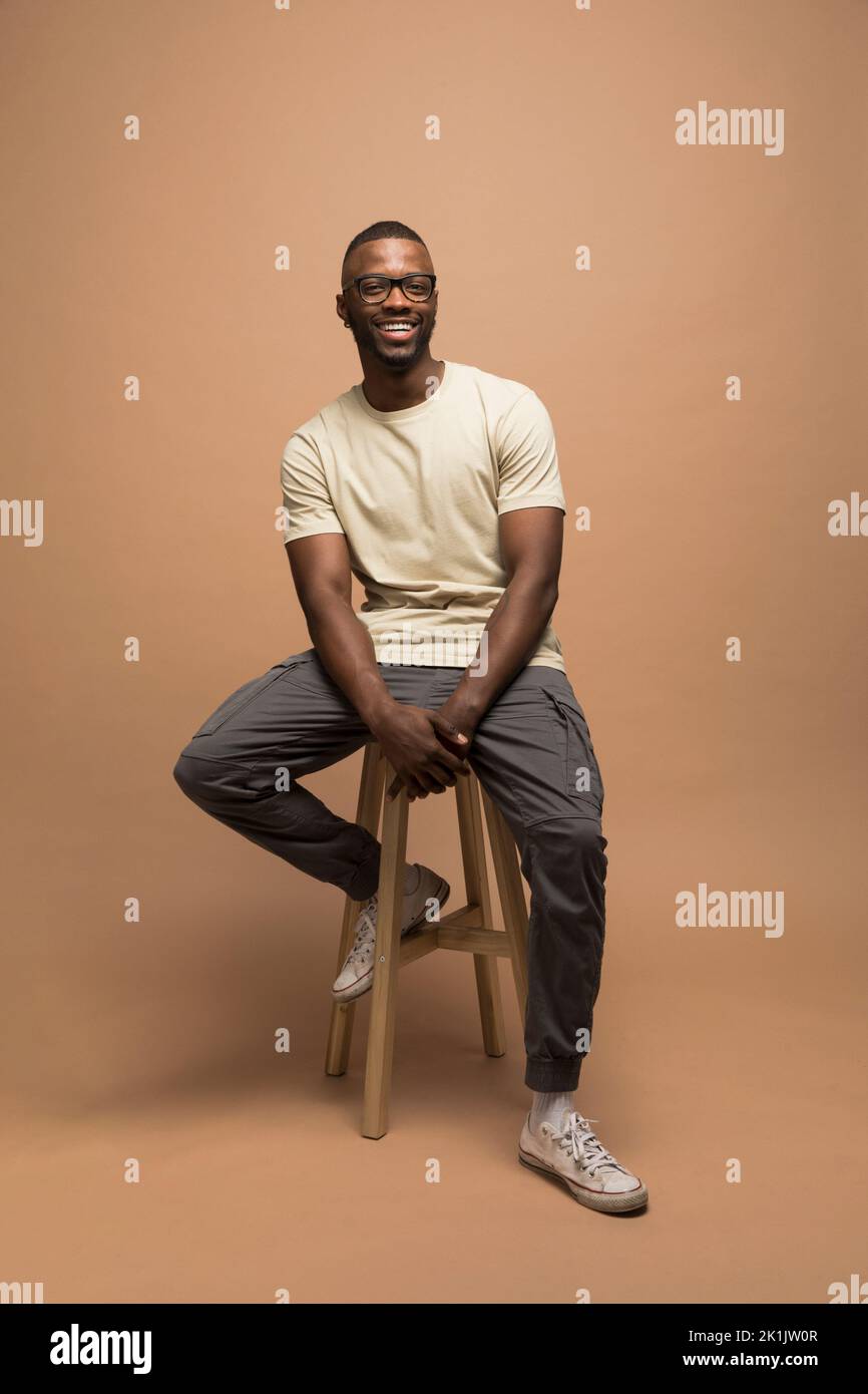 Portrait man sitting on stool hi-res stock photography and images - Alamy