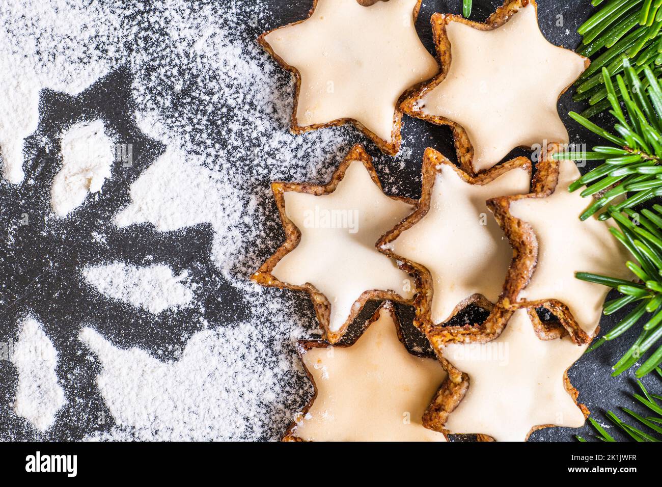 Christmas decorated cinnamon stars with a star made of sieved flour Stock Photo