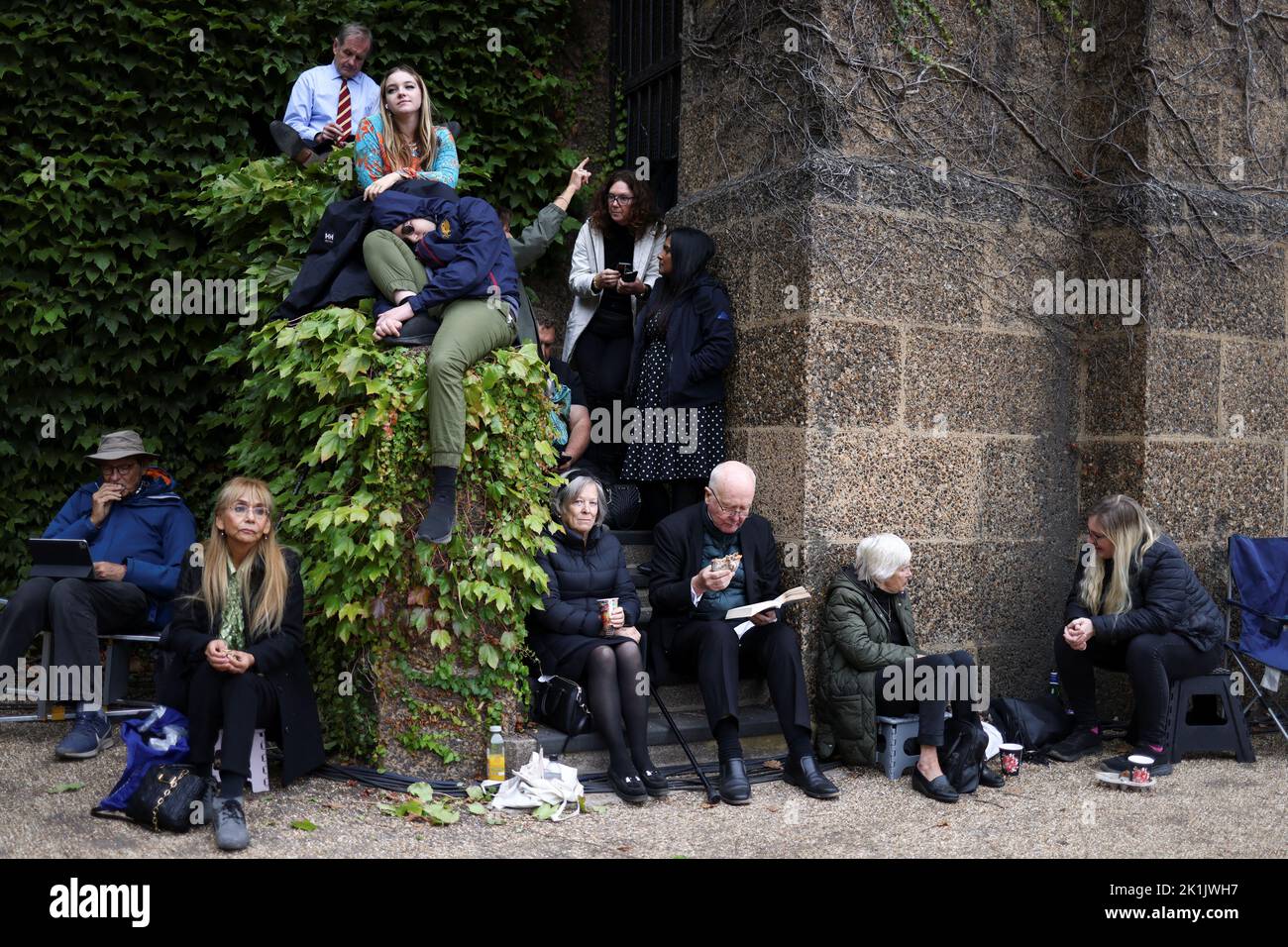 People sit on the day of the state funeral and burial of Britain's Queen Elizabeth, in London, Britain, September 19, 2022. REUTERS/Tom Nicholson Stock Photo