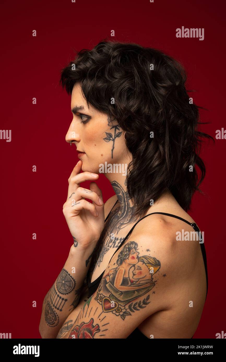 Profile portrait of thoughtful transgender woman with tattoos Stock Photo