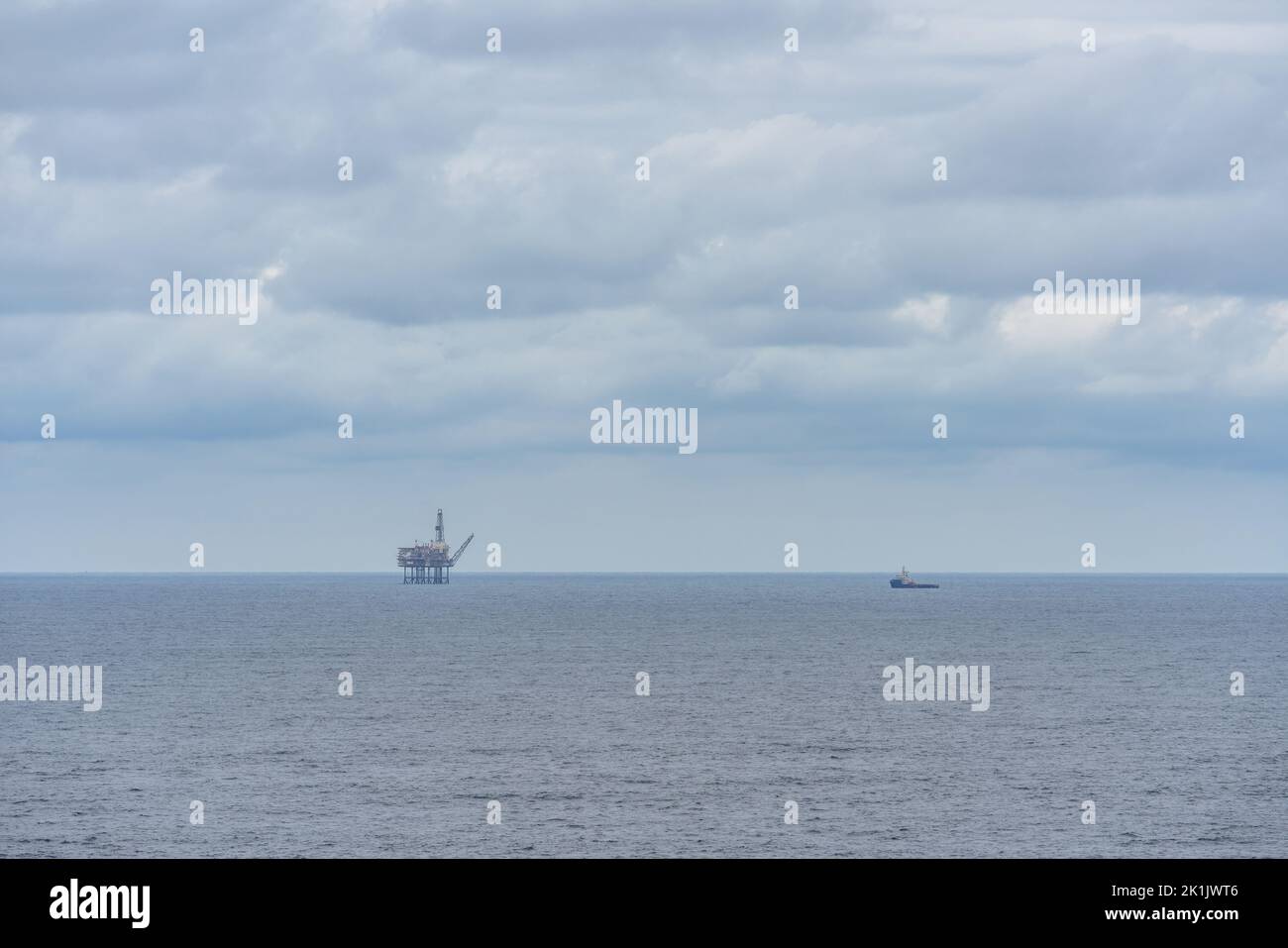 Oil or gas platform and a ship in the sea Stock Photo