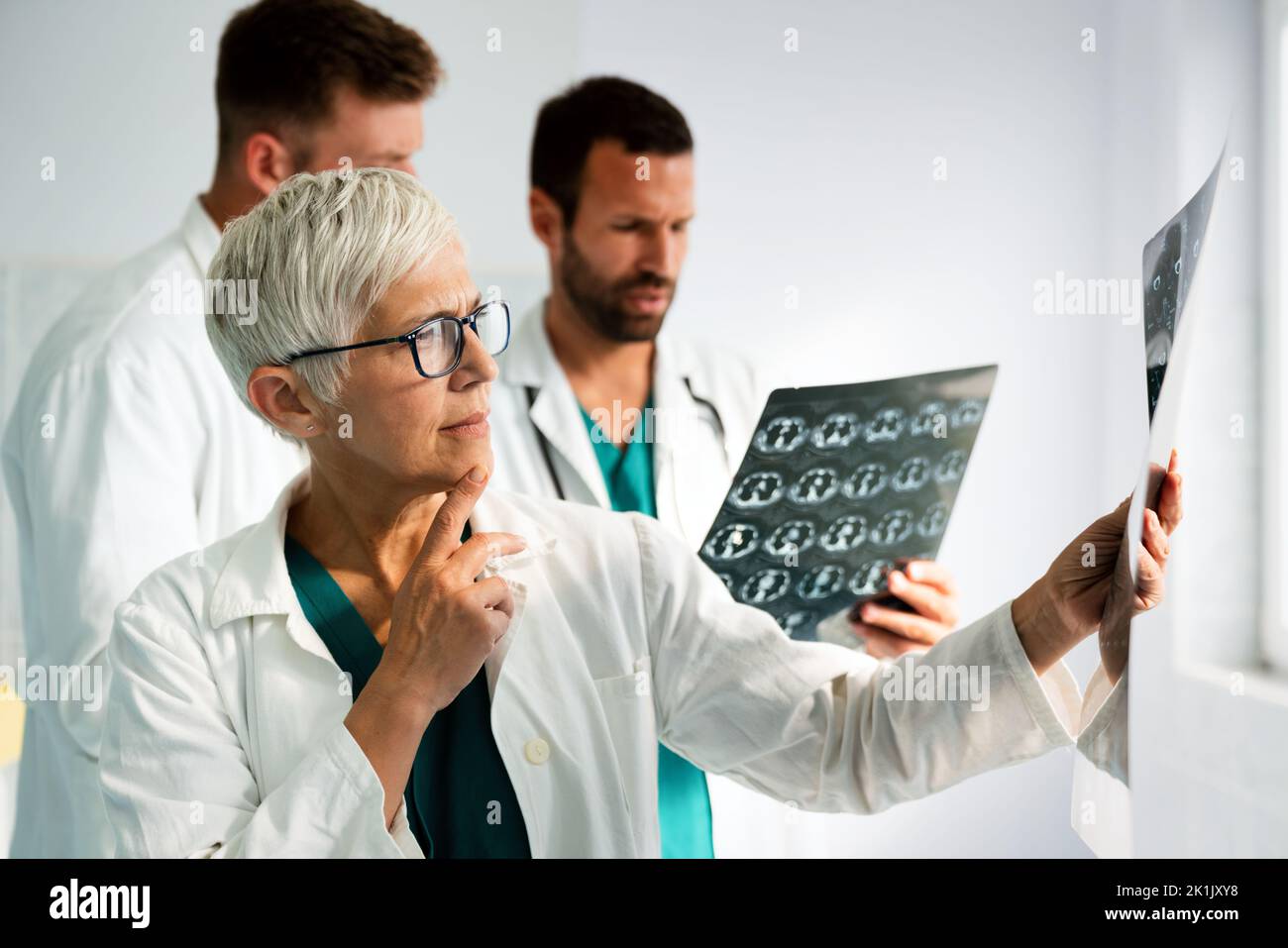 Medical team doctors checking on X-ray results in hospital Stock Photo ...